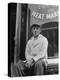 Butcher Taking a Break, Sitting in Front of Meat Market-Ed Clark-Premier Image Canvas