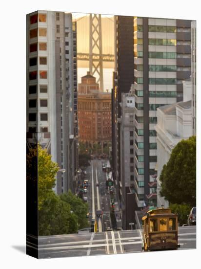 Cable Car Crossing California Street With Bay Bridge Backdrop in San Francisco, California, USA-Chuck Haney-Premier Image Canvas