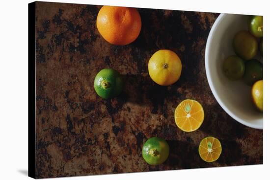 Calamansi Fruit Shown Sliced And Whole On A Rustic Background-Shea Evans-Stretched Canvas