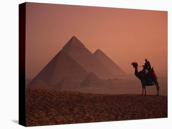 Camel and Rider at Giza Pyramids, UNESCO World Heritage Site, Giza, Cairo, Egypt-Howell Michael-Premier Image Canvas