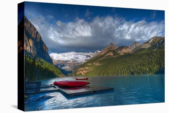 Canada, Alberta, Banff National Park. Canoes on Lake Louise dock at sunrise.-Jaynes Gallery-Premier Image Canvas