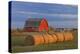 Canada, Alberta, Grande Prairie. Red Barn and Hay Bales at Sunset-Jaynes Gallery-Premier Image Canvas
