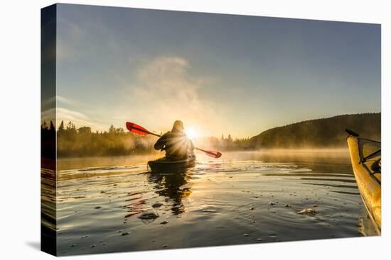 Canada, British Columbia. A kayaker paddles in morning mist on a Canadian lake.-Gary Luhm-Premier Image Canvas