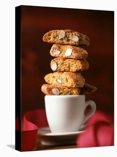 Cantucci Biscuits Piled on a Coffee Cup-Luzia Ellert-Premier Image Canvas