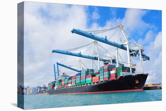 Cargo Ship at Miami Harbor with Crane and Blue Sky over Sea.-Songquan Deng-Premier Image Canvas