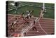 Carl Lewis Crosses the Finishing Line at the Los Angeles Olympics-null-Premier Image Canvas