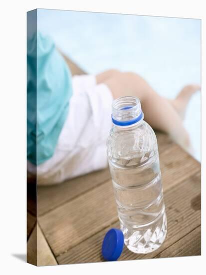 Child Sitting Beside Bottle of Water on Edge of Pool-null-Premier Image Canvas