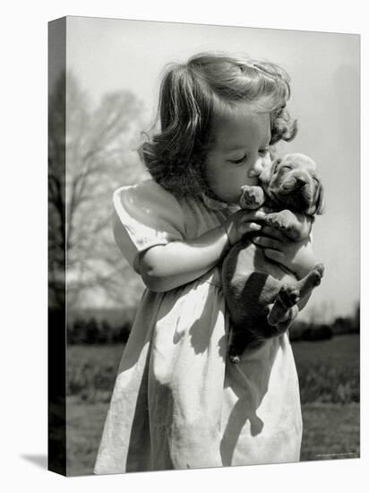 Christina Goldsmith Kissing a Weimaraner Puppy from Her Father's Stock of Weimaraner Hunting Dogs-Bernard Hoffman-Premier Image Canvas