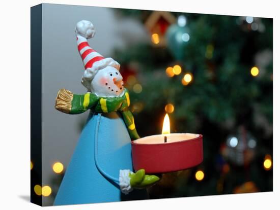 Close-Up of a Snow Man Candle in Front of a Tree with Christmas Lights-Winfred Evers-Premier Image Canvas