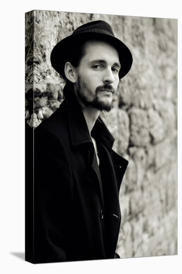 Close Up of Young Male Figure Wearing Black Jacket and Hat with Beard-Torsten Richter-Premier Image Canvas