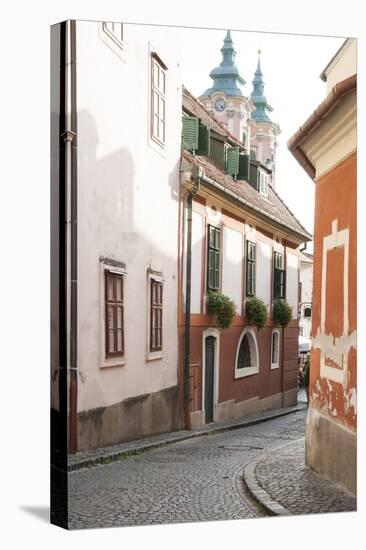 Cobblestone Street and Narrow Buildings with Church Towers in Background, Eger, Hungary-Kimberly Walker-Premier Image Canvas