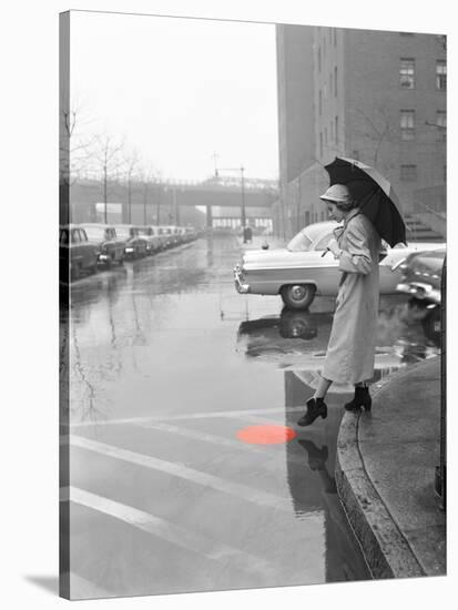 Color Pop,1950s WOMAN IN RAIN COAT HAT BOOTS HOLDING UMBRELLA CROSSING CITY STREET-null-Premier Image Canvas