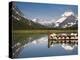 Colorful Canoes Line the Dock at Many Glacier Lodge on Swiftcurrent Lake During Sunrise-Brad Beck-Premier Image Canvas