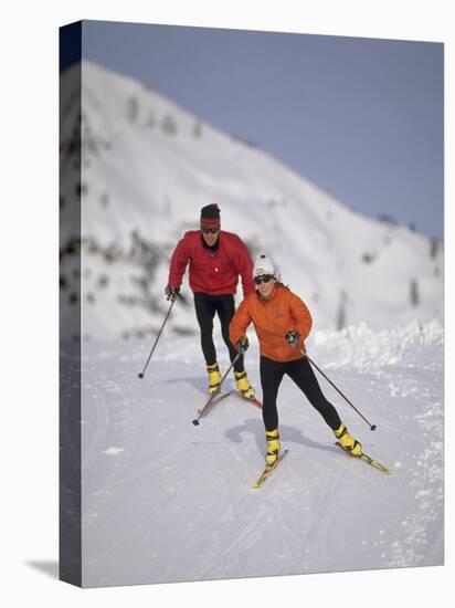 Colorful Couple Cross Country Skiing-null-Premier Image Canvas