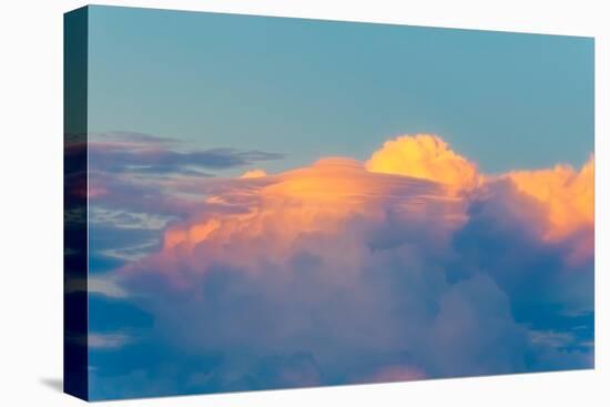 Colorful sunset clouds in deep blue sky, with a thunderhead emerging behind a lenticular cloud.-Sheila Haddad-Premier Image Canvas