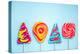 Colorful Vibrant Lollipops, Flat Lay on Blue Background-Marcin Jucha-Premier Image Canvas