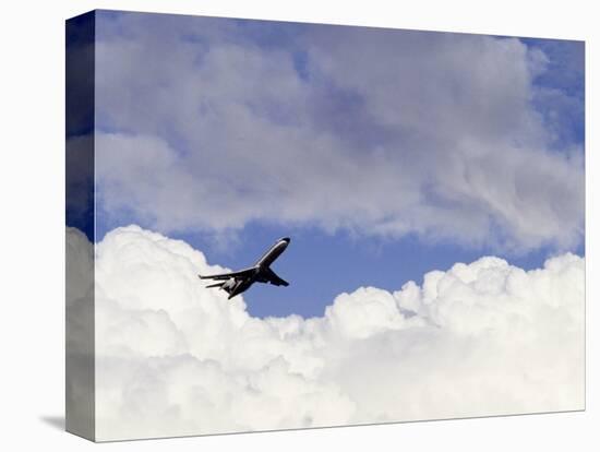 Commercial Airplane Soaring Above the Clouds-Mitch Diamond-Premier Image Canvas