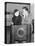Couple Leaning on a Radio and Looking at Each Other-null-Stretched Canvas