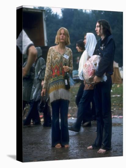 Couple Standing Barefoot on a Road Holding a Bundle and Wine Bottle, Woodstock Music and Art Fair-John Dominis-Premier Image Canvas