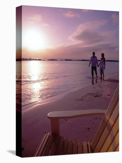 Couple Walking Along Beach at Sunset, Nassau, Bahamas, Caribbean-Greg Johnston-Premier Image Canvas