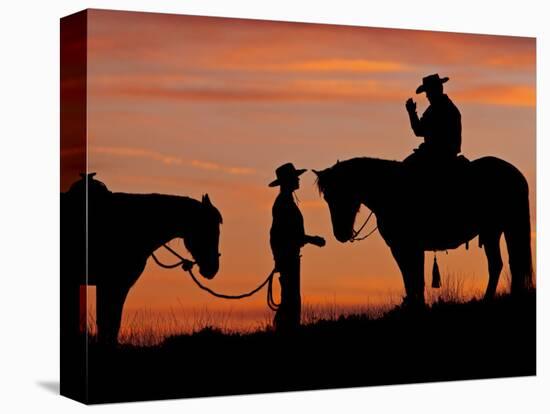 Cowboy and Cowgirl Silhouetted on a Ridge in the Big Horn Mountains, Wyoming, USA-Joe Restuccia III-Premier Image Canvas