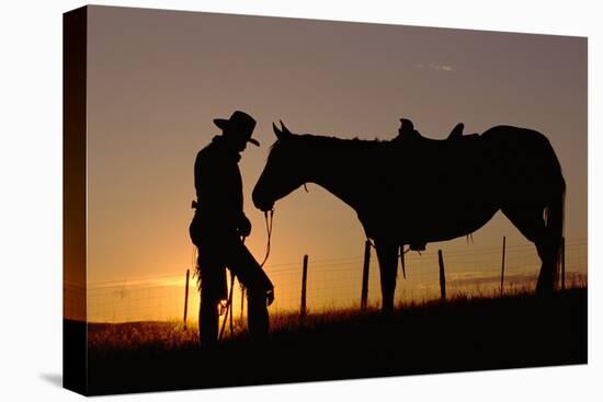 Cowboy Standing with His Horse-Darrell Gulin-Premier Image Canvas