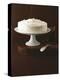 Cream Layer Cake on a Cake Stand Next to a Pot of Cinnamon Sticks - Conde Nast Collection-null-Premier Image Canvas