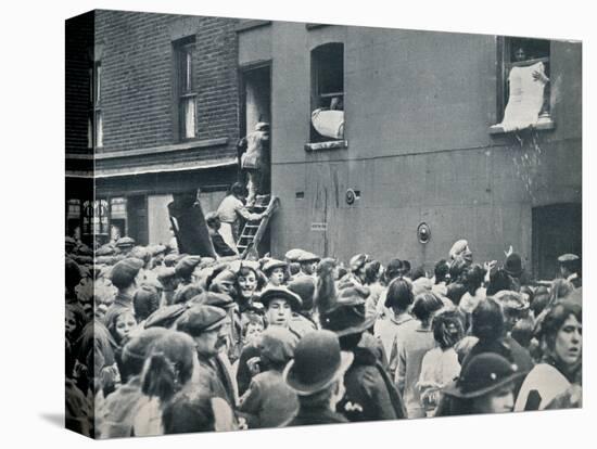 Crowd watching the looting of a German house in Poplar, c1914-Unknown-Premier Image Canvas