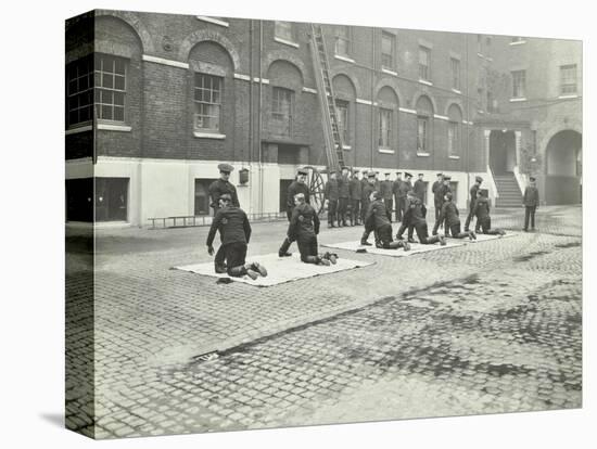 Demonstrating How to Pick Up an Unconscious Person, London Fire Brigade Headquarters, London, 1910-null-Premier Image Canvas