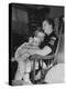 Den Mother Still in Uniform, Sleeping While Holding Her Daughter-null-Premier Image Canvas