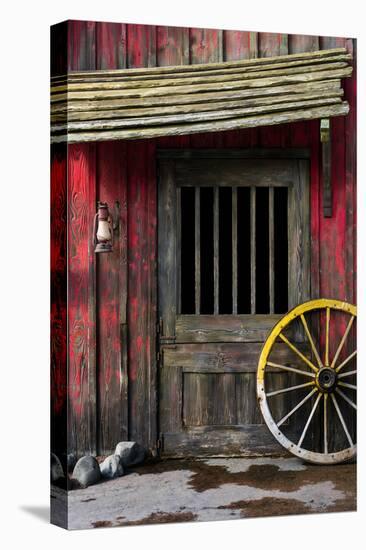 Detail of Old Wagon Wheel next to a Wooden Wild West Typical House-ccaetano-Premier Image Canvas