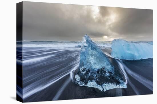 Diamond ice chards from calving icebergs on black sand beach, Jokulsarlon, south Iceland-Chuck Haney-Premier Image Canvas