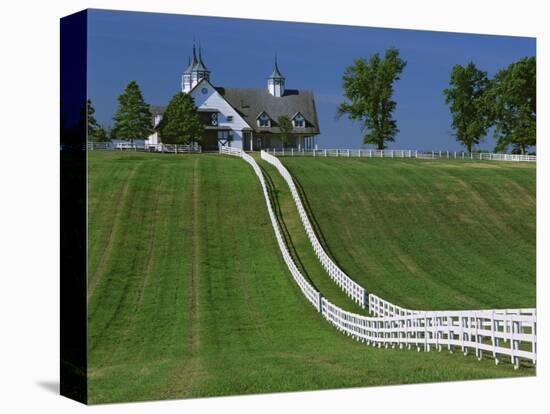 Double White Fence Flows from an Elegant Horse Barn, Woodford County, Kentucky, USA-Dennis Flaherty-Premier Image Canvas