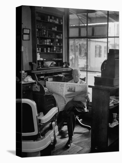Elderly Barber Sitting Reading the Morning Paper in Small Village Shop in Small New England Town-Yale Joel-Premier Image Canvas