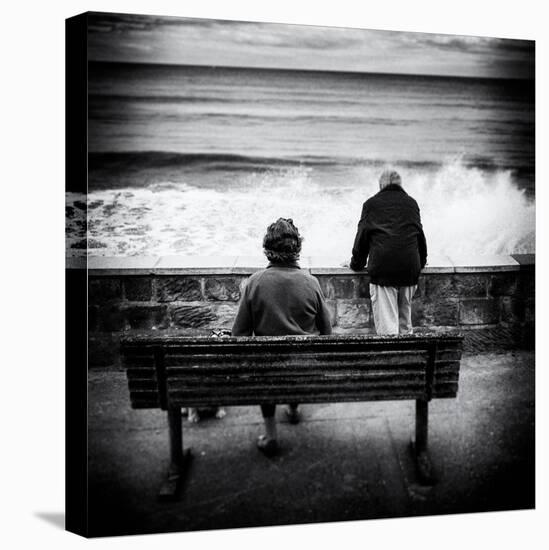 Elderly Couple Watch the Waves-Rory Garforth-Premier Image Canvas