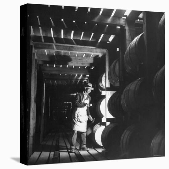 Employee in Warehouse of Jack Daniels Distillery Checking For Leaks in the Barrels-Ed Clark-Premier Image Canvas