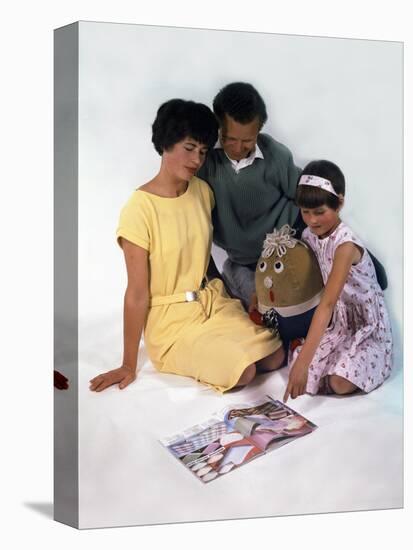 Family Group Looking at a Magazine, 1963-Michael Walters-Premier Image Canvas