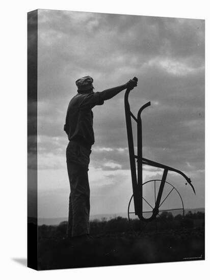 Farmer Plowing the Fields-Ed Clark-Premier Image Canvas