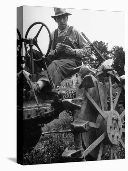 Farmer Sitting on Plow-null-Premier Image Canvas