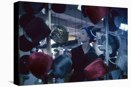 Fashion Model Katherine Gill Tries on a Hat at Christian Dior, New York, New York, 1960-Walter Sanders-Premier Image Canvas