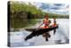 Father and son from the Yanomami tribe in a canoe, southern Venezuela-Michael Runkel-Premier Image Canvas