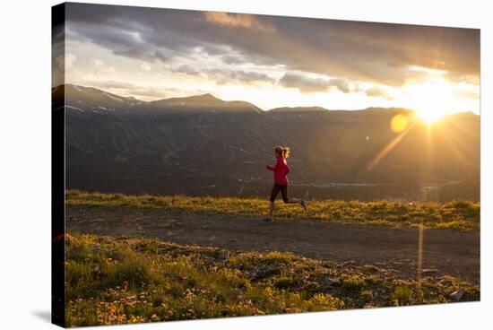 Female Runner At Sunset In The Colorado Rockies In Breckenridge-Liam Doran-Stretched Canvas