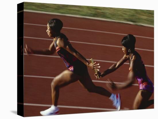 Female Runner Competing in a Relay Track Race-null-Premier Image Canvas