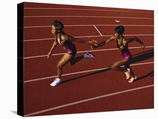 Female Runner Competing in a Relay Track Race-null-Premier Image Canvas