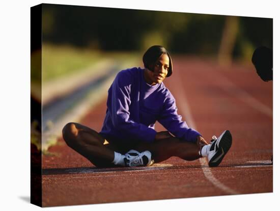 Female Runner Stretching While Training on the Track-null-Premier Image Canvas