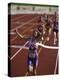 Female Runner Victorious at the Finish Line in a Track Race-null-Premier Image Canvas