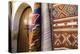 Fez Morocco decorative door and hanging patterned carpets in the old medina-Ellen Clark-Premier Image Canvas