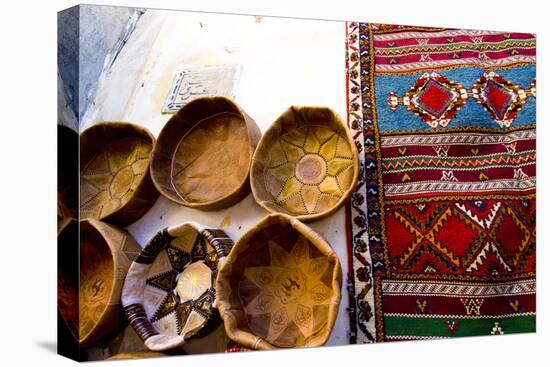 Fez Morocco leather baskets & oriental carpet on the wall in the old medina-Ellen Clark-Premier Image Canvas