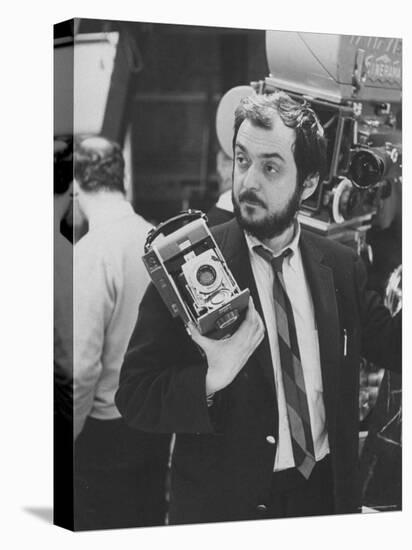 Film Director Stanley Kubrick Holding Polaroid Camera During Filming of "2001: A Space Odyssey"-Dmitri Kessel-Premier Image Canvas