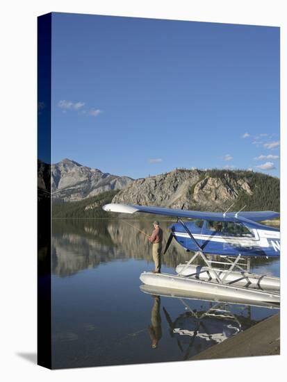 Fisherman and Floatplane, Takahula Lake, Alaska, USA-Hugh Rose-Premier Image Canvas